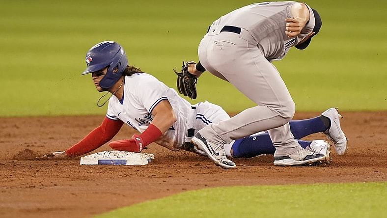 Sep 28, 2021; Toronto, Ontario, CAN; Toronto Blue Jays shortstop Bo Bichette (11) steals second base against New York Yankees second baseman Gleyber Torres (25) during the first inning at Rogers Centre. Mandatory Credit: John E. Sokolowski-USA TODAY Sports