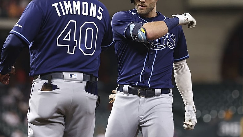 Sep 28, 2021; Houston, Texas, USA; Tampa Bay Rays center fielder Kevin Kiermaier (39) celebrates with first base coach Ozzie Timmons (40) after hitting a single against the Houston Astros during the second inning at Minute Maid Park. Mandatory Credit: Troy Taormina-USA TODAY Sports
