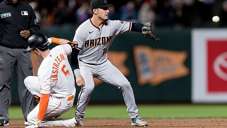 Sep 28, 2021; San Francisco, California, USA; San Francisco Giants right fielder Mike Yastrzemski (5) slides into second base with a double against Arizona Diamondbacks shortstop Josh Rojas (10) in the fourth inning at Oracle Park. Mandatory Credit: John Hefti-USA TODAY Sports