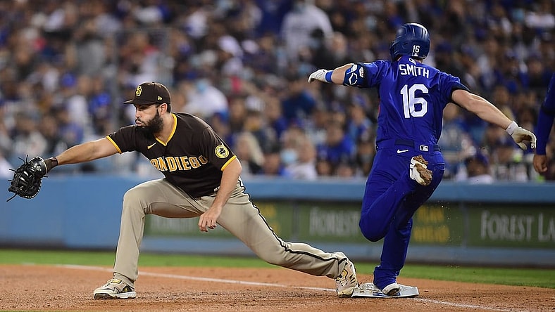 Sep 28, 2021; Los Angeles, California, USA; Los Angeles Dodgers catcher Will Smith (16) is out at first against San Diego Padres first baseman Eric Hosmer (30) during the third inning at Dodger Stadium. Mandatory Credit: Gary A. Vasquez-USA TODAY Sports