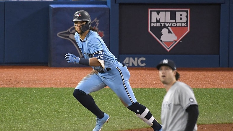 Sep 29, 2021; Toronto, Ontario, CAN; Toronto Blue Jays shortstop Bo Bichette (left) rounds the bases after hitting a solo home run against New York Yankees pitcher Gerrit Cole (front) in the third inning at Rogers Centre. Mandatory Credit: Dan Hamilton-USA TODAY Sports