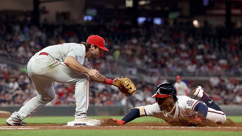 Sep 29, 2021; Atlanta, Georgia, USA; Atlanta Braves second baseman Ozzie Albies (1) slides back to first base safely on a pickoff attempt by Philadelphia Phillies first baseman Matt Vierling (19) during the third inning at Truist Park. Mandatory Credit: Jason Getz-USA TODAY Sports
