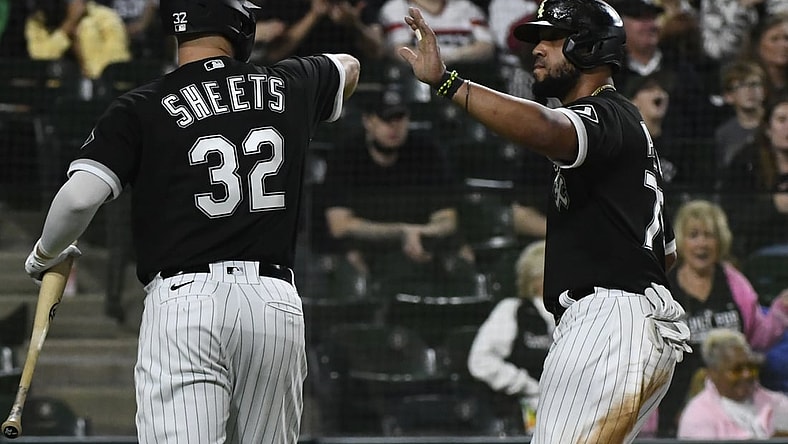 Sep 29, 2021; Chicago, Illinois, USA; Chicago White Sox first baseman Jose Abreu (right) celebrates with designated hitter Gavin Sheets (32) after scoring against the Cincinnati Reds during the fourth inning at Guaranteed Rate Field. Mandatory Credit: Matt Marton-USA TODAY Sports