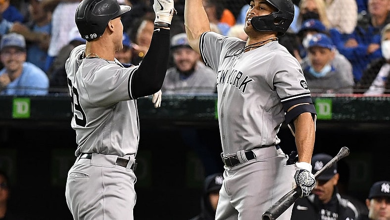 Sep 30, 2021; Toronto, Ontario, CAN;   New York Yankees right fielder Aaron Judge (99) is greeted by left fielder Giancarlo Stanton (27) after hitting a solo home run against Toronto Blue Jays in the first inning at Rogers Centre. Mandatory Credit: Dan Hamilton-USA TODAY Sports