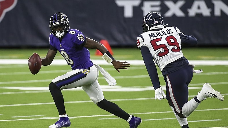 Sep 20, 2020; Houston, Texas, USA; Baltimore Ravens quarterback Lamar Jackson (8) rolls out of the pocket with the ball as Houston Texans outside linebacker Whitney Mercilus (59) applies defensive pressure during the second quarter at NRG Stadium. Mandatory Credit: Troy Taormina-USA TODAY Sports