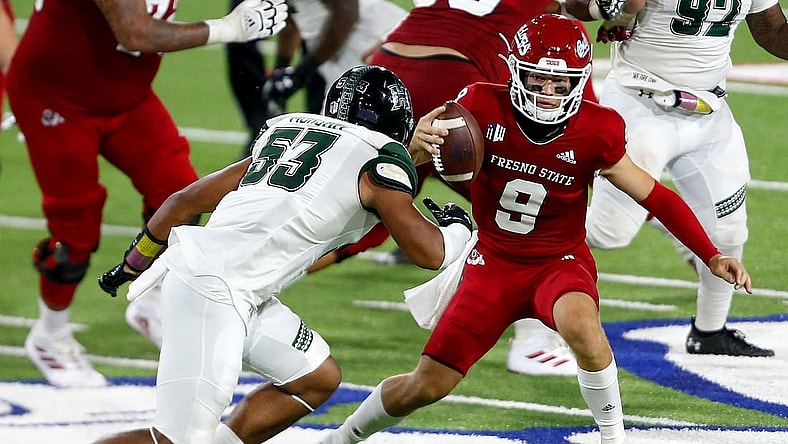 Oct 24, 2020; Fresno, California, USA; Fresno State Bulldogs quarterback Jake Haener (9) rushes the ball against Hawaii Rainbow Warriors linebacker Darius Muasau (53) during the third quarter at Bulldog Stadium. Mandatory Credit: Kiel Maddox-USA TODAY Sports