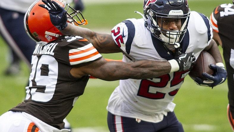 Nov 15, 2020; Cleveland, Ohio, USA; Houston Texans running back Duke Johnson (25) stiff arms Cleveland Browns cornerback Terrance Mitchell (39) as he moves in for the tackle during the second quarter at FirstEnergy Stadium. Mandatory Credit: Scott Galvin-USA TODAY Sports