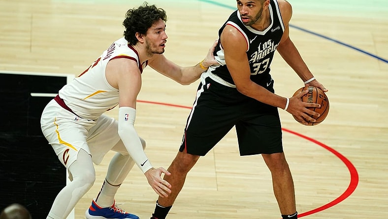 Feb 14, 2021; Los Angeles, California, USA; LA Clippers forward Nicolas Batum (33) is defended by Cleveland Cavaliers forward Cedi Osman (16) in the first half at Staples Center. Mandatory Credit: Kirby Lee-USA TODAY Sports