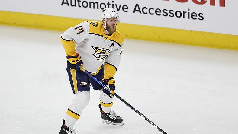 Apr 23, 2021; Chicago, Illinois, USA; Nashville Predators defenseman Mattias Ekholm (14) looks to pass the puck against the Chicago Blackhawks during the first period of an NHL hockey game at United Center. Mandatory Credit: Kamil Krzaczynski-USA TODAY Sports