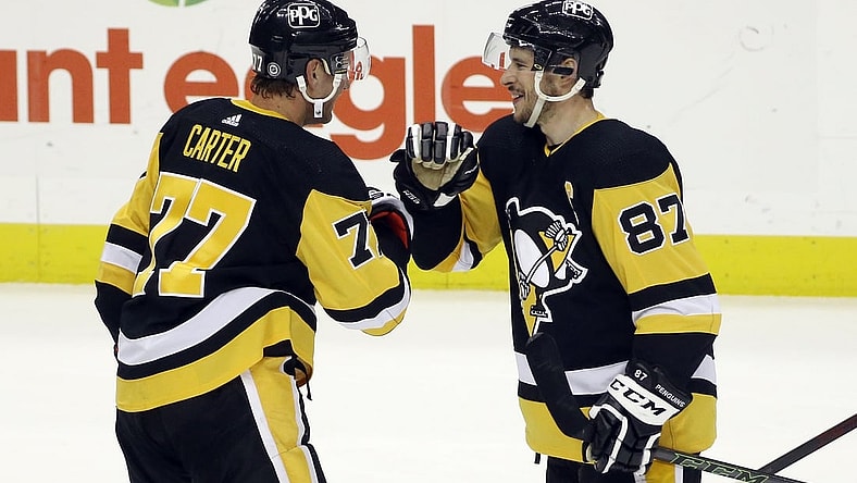 May 6, 2021; Pittsburgh, Pennsylvania, USA;  Pittsburgh Penguins center Jeff Carter (77) and center Sidney Crosby (87) celebrate after defeating the Buffalo Sabres at PPG Paints Arena. Pittsburgh won 8-4. Mandatory Credit: Charles LeClaire-USA TODAY Sports