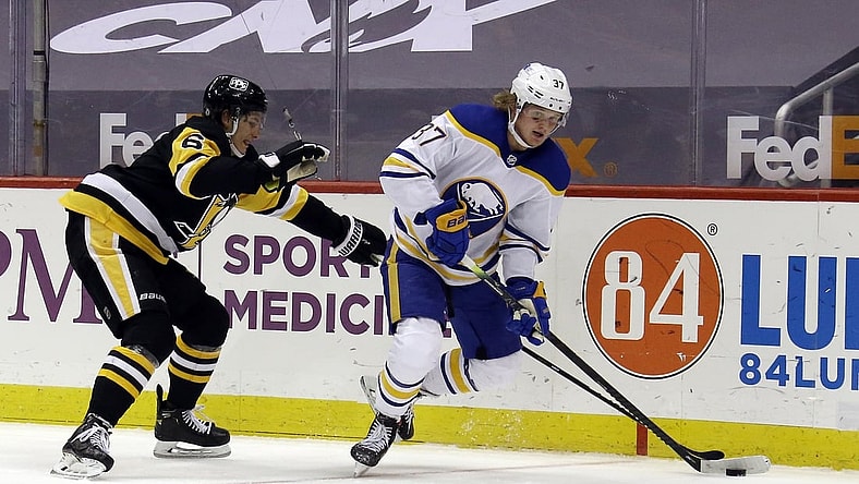 May 8, 2021; Pittsburgh, Pennsylvania, USA;  Buffalo Sabres center Casey Mittelstadt (37) moves the puck against Pittsburgh Penguins defenseman John Marino (6) during the second period at PPG Paints Arena. Mandatory Credit: Charles LeClaire-USA TODAY Sports