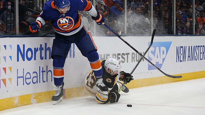 Jun 9, 2021; Uniondale, New York, USA; Boston Bruins center Brad Marchand (63) and New York Islanders defenseman Ryan Pulock (6) fight for the puck during the third period of game six of the third round of the 2021 Stanley Cup Playoffs at Nassau Veterans Memorial Coliseum. Mandatory Credit: Brad Penner-USA TODAY Sports