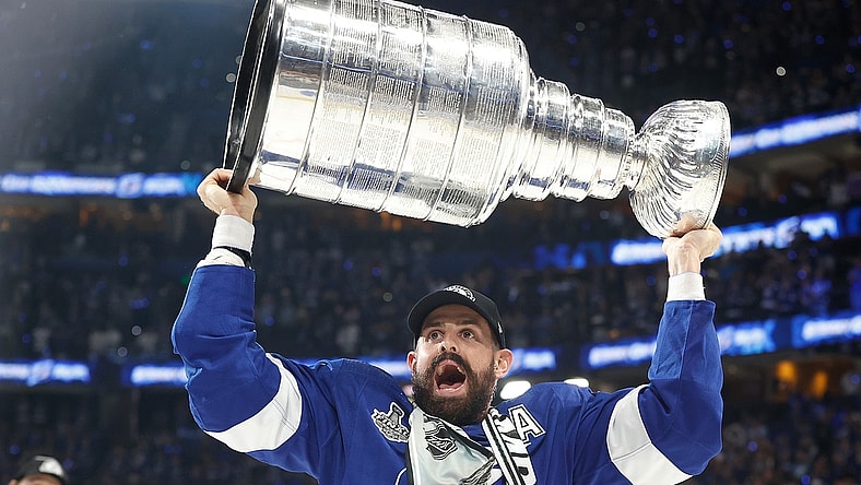 Jul 7, 2021; Tampa, Florida, USA;  Tampa Bay Lightning left wing Alex Killorn (17) hoists the Stanley Cup after the Lightning defeated the Montreal Canadiens 1-0 in game five to win the 2021 Stanley Cup Final at Amalie Arena. Mandatory Credit: Kim Klement-USA TODAY Sports