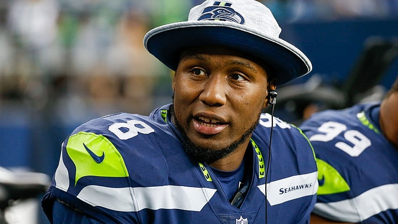 Aug 28, 2021; Seattle, Washington, USA; Seattle Seahawks defensive end Carlos Dunlap (8) sits on the bench during the second quarter against the Los Angeles Chargers at Lumen Field. Mandatory Credit: Joe Nicholson-USA TODAY Sports