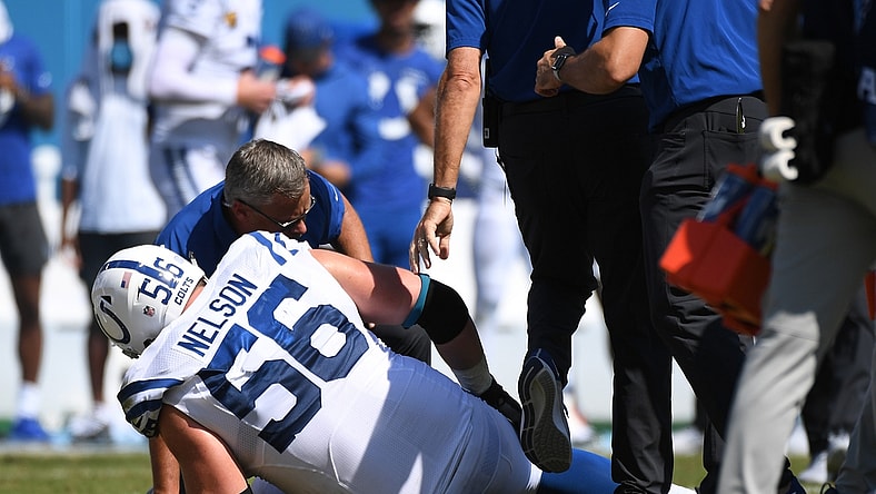 Sep 26, 2021; Nashville, Tennessee, USA; Indianapolis Colts offensive guard Quenton Nelson (56) is checked on by the team trainer after an injury during the first half against the Tennessee Titans at Nissan Stadium. Mandatory Credit: Christopher Hanewinckel-USA TODAY Sports