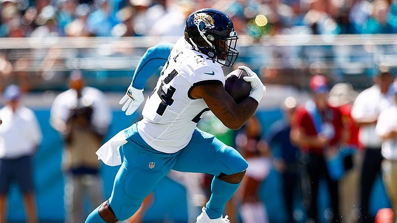 Sep 26, 2021; Jacksonville, Florida, USA; Jacksonville Jaguars running back Carlos Hyde (24) runs with the ball in the second quarter against the Arizona Cardinals at TIAA Bank Field. Mandatory Credit: Nathan Ray Seebeck-USA TODAY Sports