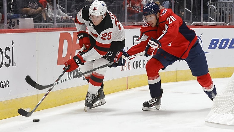 Sep 29, 2021; Washington, District of Columbia, USA; New Jersey Devils left wing Nolan Foote (25) skates with the puck as Washington Capitals defenseman Vincent Iorio (28) defends during the first period at Capital One Arena. Mandatory Credit: Geoff Burke-USA TODAY Sports