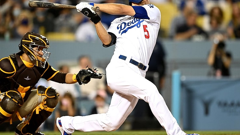 Sep 30, 2021; Los Angeles, California, USA; Los Angeles Dodgers shortstop Corey Seager (5) hits a solo home run in the first inning of the game against the San Diego Padres at Dodger Stadium. Mandatory Credit: Jayne Kamin-Oncea-USA TODAY Sports