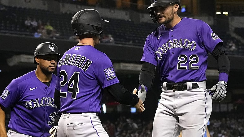 Oct 1, 2021; Phoenix, Arizona, USA; Colorado Rockies right fielder Sam Hilliard (22) celebrates with Ryan McMahon (24) after hitting a homerun against the Arizona Diamondbacks in the sixth inning at Chase Field. Mandatory Credit: Rick Scuteri-USA TODAY Sports
