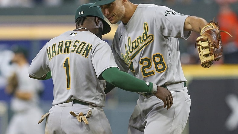 Oct 1, 2021; Houston, Texas, USA; Oakland Athletics third baseman Josh Harrison (1) hugs first baseman Matt Olson (28) after defeating the Houston Astros at Minute Maid Park. Mandatory Credit: Thomas Shea-USA TODAY Sports