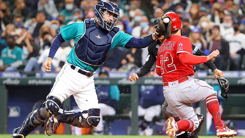 Oct 1, 2021; Seattle, Washington, USA;  Los Angeles Angels second baseman David Fletcher (22) beats the tag by Seattle Mariners catcher Tom Murphy (2) to score and take a 2-1 lead during the third inning at T-Mobile Park. Mandatory Credit: Abbie Parr-USA TODAY Sports