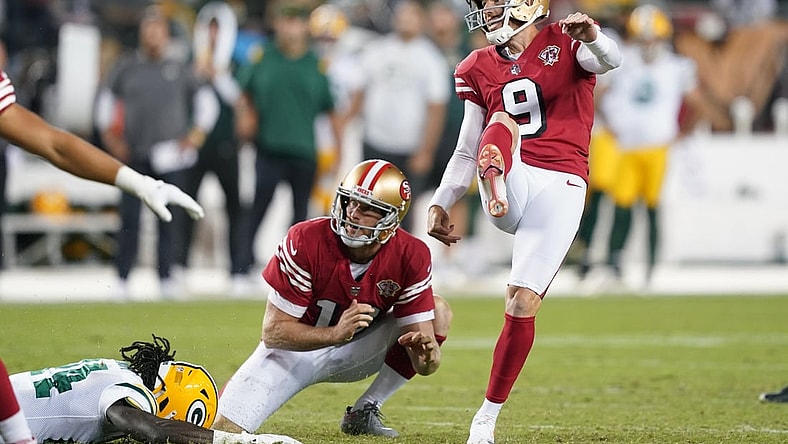 Sep 26, 2021; Santa Clara, California, USA; San Francisco 49ers kicker Robbie Gould (9) kicks an extra point as punter Mitch Wishnowsky (18) holds during the fourth quarter against the Green Bay Packers at Levi's Stadium. Mandatory Credit: Darren Yamashita-USA TODAY Sports
