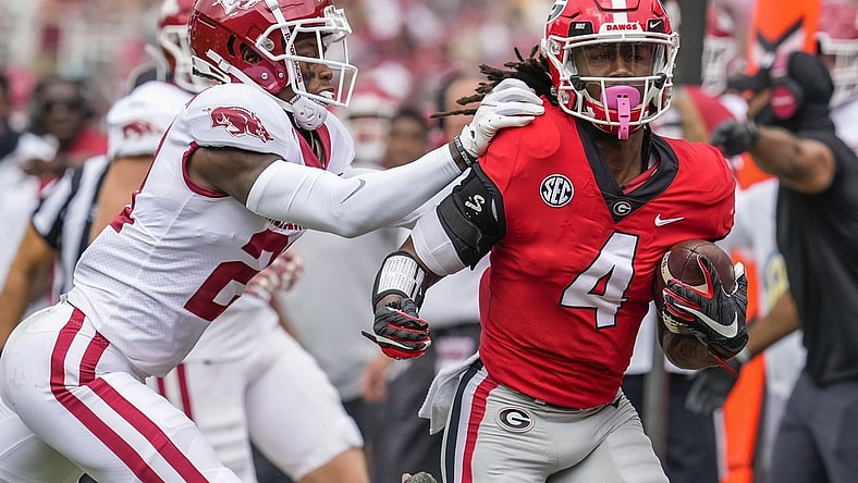 Oct 2, 2021; Athens, Georgia, USA; Georgia Bulldogs running back James Cook (4) gets knocked out of bounds by Arkansas Razorbacks defensive back Montaric Brown (21) during the first quarter at Sanford Stadium. Mandatory Credit: Dale Zanine-USA TODAY Sports