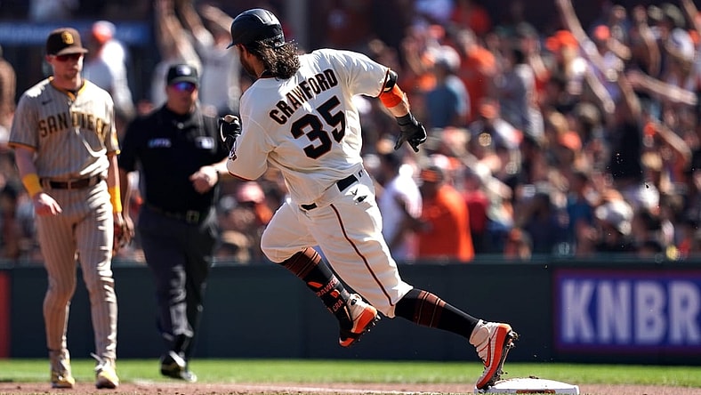 Oct 2, 2021; San Francisco, California, USA; San Francisco Giants shortstop Brandon Crawford (35) rounds first base on a double during the second inning against the San Diego Padres at Oracle Park. Mandatory Credit: Darren Yamashita-USA TODAY Sports