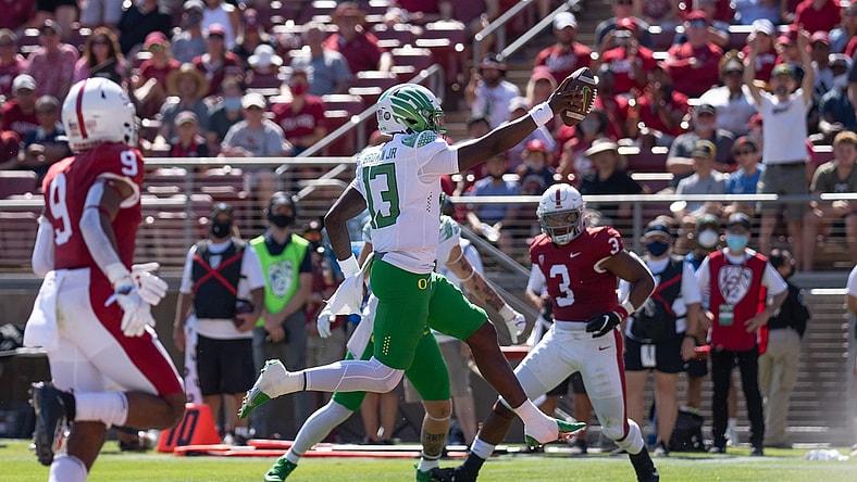 Oct 2, 2021; Stanford, California, USA;  Oregon Ducks quarterback Anthony Brown (13) scores during the second quarter against the Stanford Cardinal at Stanford Stadium. Mandatory Credit: Stan Szeto-USA TODAY Sports