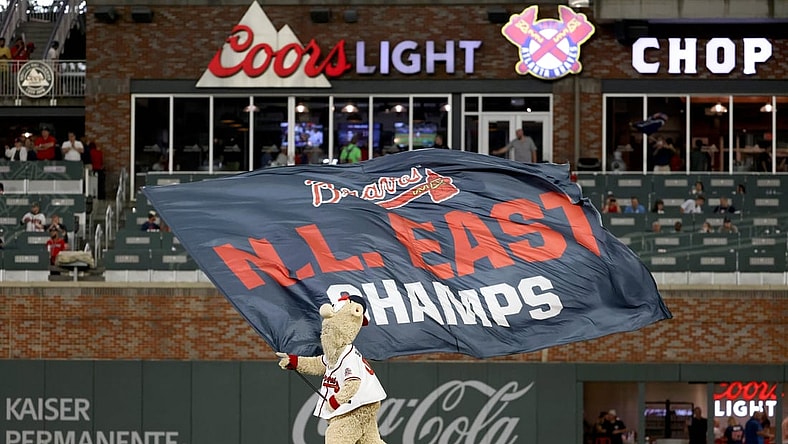 Oct 2, 2021; Atlanta, Georgia, USA; Atlanta Braves mascot Blooper waves the N.L. East Champs flag after the Atlanta Braves defeated the New York Mets at Truist Park. Mandatory Credit: Jason Getz-USA TODAY Sports