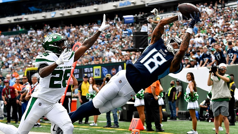 Oct 3, 2021; East Rutherford, NJ, USA;   Tennessee Titans wide receiver Josh Reynolds (18) pulls in a catch against New York Jets cornerback Brandin Echols (26) that was ruled out of bounds during the first quarter at MetLife Stadium Sunday, Oct. 3, 2021 in East Rutherford, N.J. Mandatory Credit: George Walker IV-USA TODAY Sports