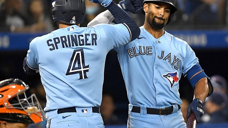 Oct 3, 2021; Toronto, Ontario, CAN;  Toronto Blue Jays center fielder George Springer (4) is greeted by second baseman Marcus Semen (10) after hitting a solo home run in the first inning at Rogers Centre. Mandatory Credit: Dan Hamilton-USA TODAY Sports