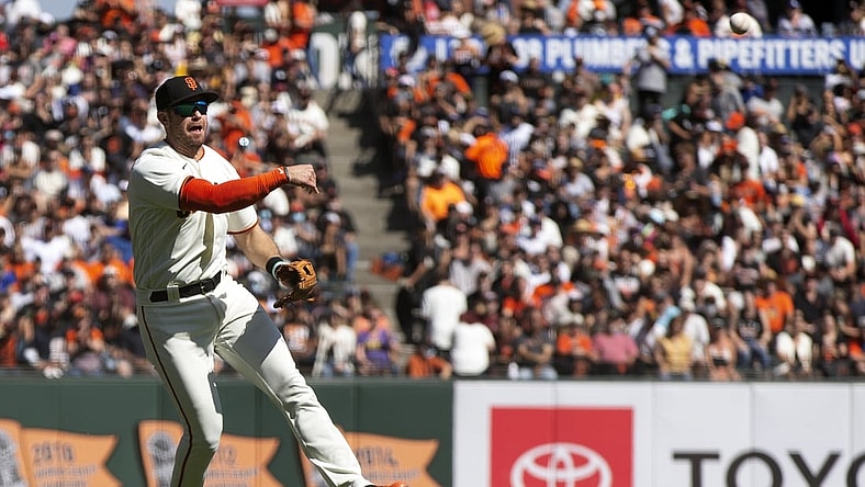Oct 3, 2021; San Francisco, California, USA; San Francisco Giants third baseman Evan Longoria (10) leaves his feet to throw out San Diego Padres shortstop Fernando Tatis Jr. at first base during the fourth inning at Oracle Park. Mandatory Credit: D. Ross Cameron-USA TODAY Sports