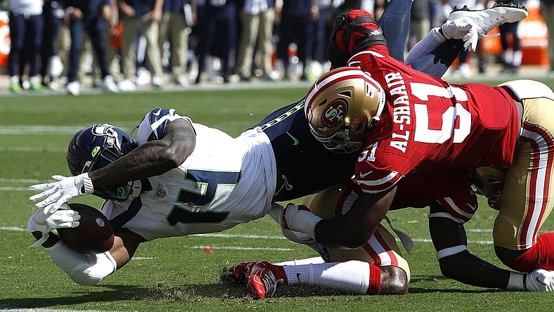 Oct 3, 2021; Santa Clara, California, USA; Seattle Seahawks wide receiver DK Metcalf (14) dives for the end zone while being tackled by San Francisco 49ers linebacker Azeez Al-Shaair (51) and cornerback Jimmie Ward (1) during the second quarter at Levi's Stadium. Mandatory Credit: Darren Yamashita-USA TODAY Sports
