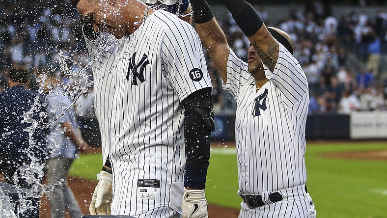 Oct 3, 2021; Bronx, New York, USA;  New York Yankees right fielder Aaron Judge (99) is doused with water after his game winning RBI single to defeat the Tampa Bay Rays 1-0 and clinch a wildcard playoff spot at Yankee Stadium. Mandatory Credit: Wendell Cruz-USA TODAY Sports