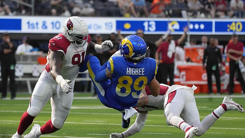 Oct 3, 2021; Inglewood, California, USA; Los Angeles Rams tight end Tyler Higbee (89) is tackled by Arizona Cardinals defensive end Michael Dogbe (91) and cornerback Byron Murphy (7) in the second half at SoFi Stadium. The Cardinals defeated the Rams 37-20. Mandatory Credit: Kirby Lee-USA TODAY Sports