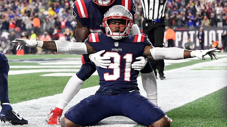 Oct 3, 2021; Foxborough, Massachusetts, USA;  New England Patriots free safety Devin McCourty (32) celebrates with defensive back Jonathan Jones (31) after breaking up a pass in the end zone during the second half of a game against the Tampa Bay Buccaneers at Gillette Stadium. Mandatory Credit: Brian Fluharty-USA TODAY Sports