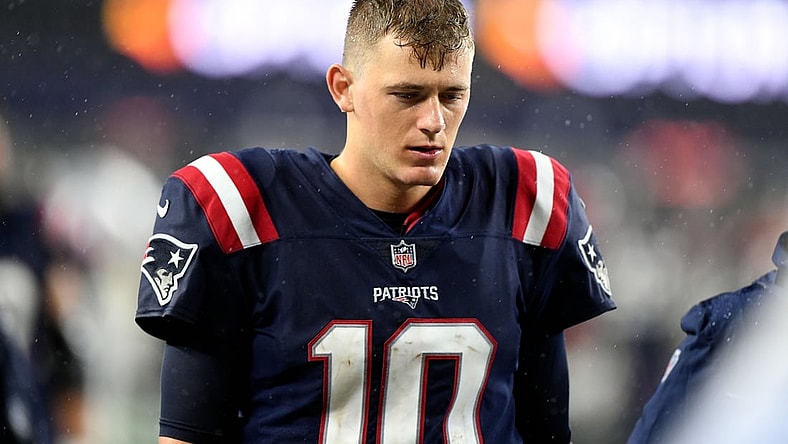 Oct 3, 2021; Foxborough, Massachusetts, USA; New England Patriots quarterback Mac Jones (10) walks off of the field after a loss to the Tampa Bay Buccaneers at Gillette Stadium. Mandatory Credit: Brian Fluharty-USA TODAY Sports