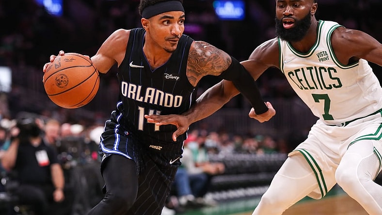 Oct 4, 2021; Boston, Massachusetts, USA; Boston Celtics guard Jaylen Brown (7) defends Orlando Magic guard Gary Harris (14) during the first half at TD Garden. Mandatory Credit: Paul Rutherford-USA TODAY Sports