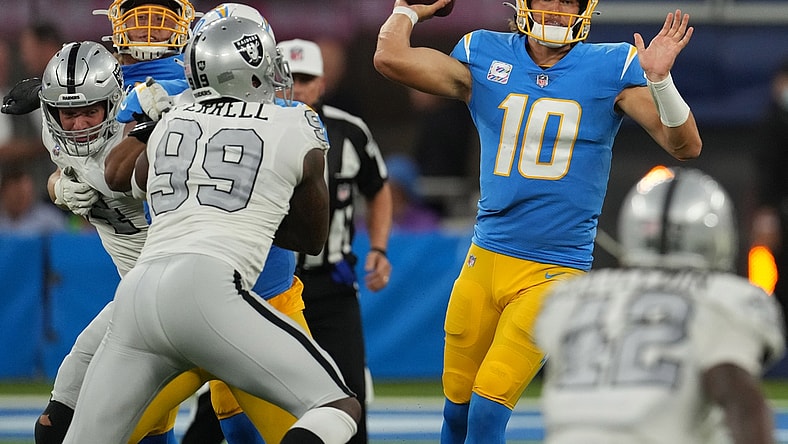 Oct 4, 2021; Inglewood, California, USA; Los Angeles Chargers quarterback Justin Herbert (10) throws a pass against the Las Vegas Raiders during the first half at SoFi Stadium. Mandatory Credit: Kirby Lee-USA TODAY Sports