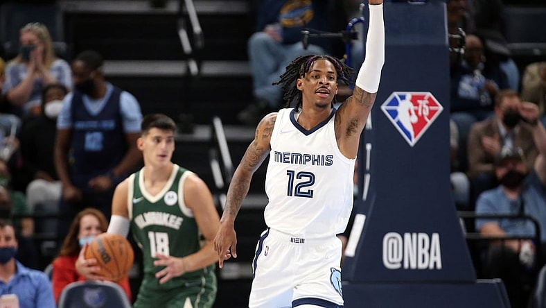 Oct 5, 2021; Memphis, Tennessee, USA; Memphis Grizzles guard Ja Morant (12) celebrates after a dunk against the Milwaukee Bucks during the third quarter at FedExForum. Mandatory Credit: Petre Thomas-USA TODAY Sports