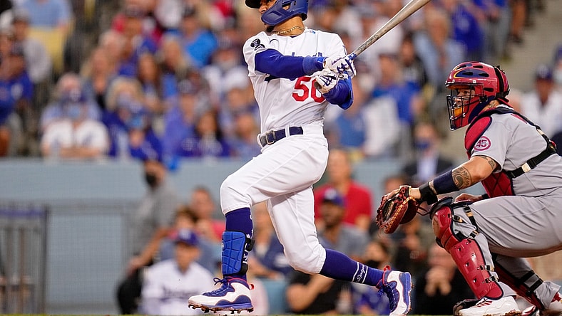 Oct 6, 2021; Los Angeles, California, USA; Los Angeles Dodgers right fielder Mookie Betts (50) hits a single against the St. Louis Cardinals the third inning at Dodger Stadium. Mandatory Credit: Robert Hanashiro-USA TODAY Sports