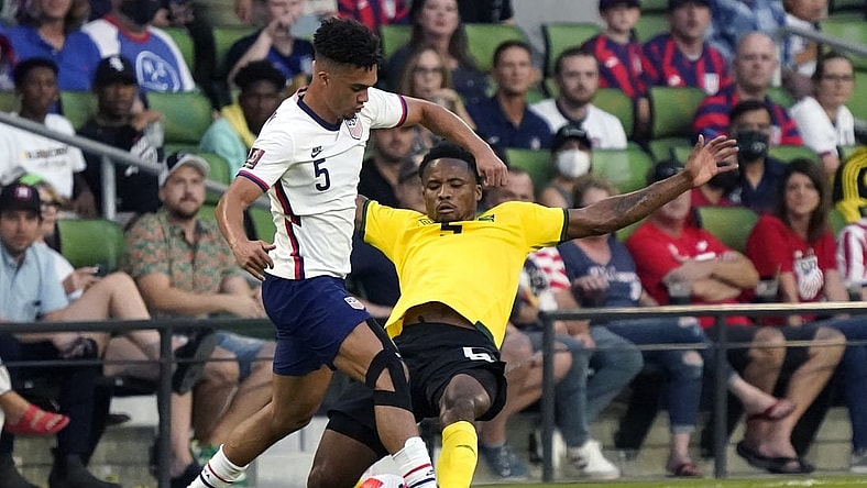 Oct 7, 2021; Austin, Texas, USA; United States defender Antonee Robinson (left) battles Jamaica defender Alvas Powel (right) during the first half of a FIFA World Cup Qualifier at Q2 Stadium. Mandatory Credit: Chuck Burton-USA TODAY Sports