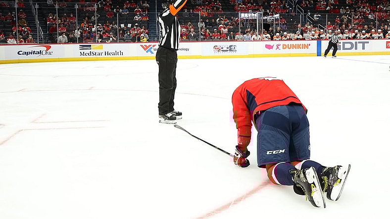 Oct 8, 2021; Washington, District of Columbia, USA; Washington Capitals left wing Alex Ovechkin (8) kneels on the ice after injuring his left knee against the Philadelphia Flyers during the first period at Capital One Arena. Mandatory Credit: Geoff Burke-USA TODAY Sports