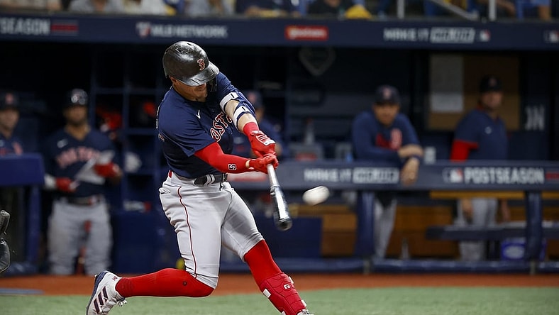 Oct 8, 2021; St. Petersburg, Florida, USA; Boston Red Sox center fielder Enrique Hernandez (5) hits a home run against the Tampa Bay Rays during the fifth inning in game two of the 2021 ALDS at Tropicana Field. Mandatory Credit: Kim Klement-USA TODAY Sports