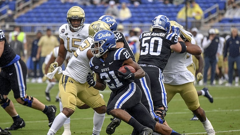 Oct 9, 2021; Durham, North Carolina, Duke Blue Devils running back Mataeo Durant (21) runs the ball against the Georgia Tech Yellow Jackets during the first quarter at Wallace Wade Stadium. Mandatory Credit: William Howard-USA TODAY Sports.