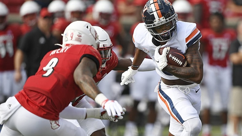 Oct 9, 2021; Louisville, Kentucky, USA;  Virginia Cavaliers wide receiver Dontayvion Wicks (3) runs the ball against Louisville Cardinals linebacker C.J. Avery (9) during the first quarter at Cardinal Stadium. Mandatory Credit: Jamie Rhodes-USA TODAY Sports