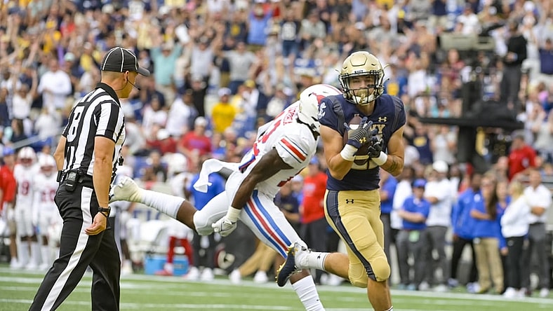 Oct 9, 2021; Annapolis, Maryland, USA;  Navy Midshipmen fullback Kai Puailoa-Rojas (21) catches a pass for a touch down as Southern Methodist Mustangs safety Isaiah Nwokobia (12) defends during the first half at Navy-Marine Corps Memorial Stadium. Mandatory Credit: Tommy Gilligan-USA TODAY Sports