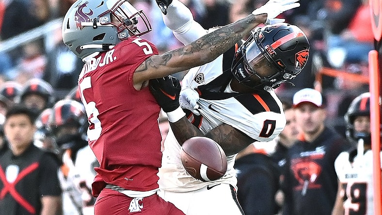 Oct 9, 2021; Pullman, Washington, USA; Washington State Cougars defensive back Derrick Langford (5) is called for pass interference on his play against Oregon State Beavers wide receiver Tre'Shaun Harrison (0) in the first half at Gesa Field at Martin Stadium. Mandatory Credit: James Snook-USA TODAY Sports