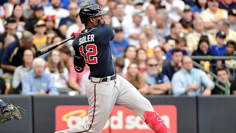 Oct 9, 2021; Milwaukee, Wisconsin, USA; Atlanta Braves right fielder Jorge Soler (12) hits a double against the Milwaukee Brewers during the second inning during game two of the 2021 NLDS at American Family Field. Mandatory Credit: Benny Sieu-USA TODAY Sports